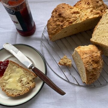 Fresh baked buttermilk soda bread, buttered and with strawberry jam.