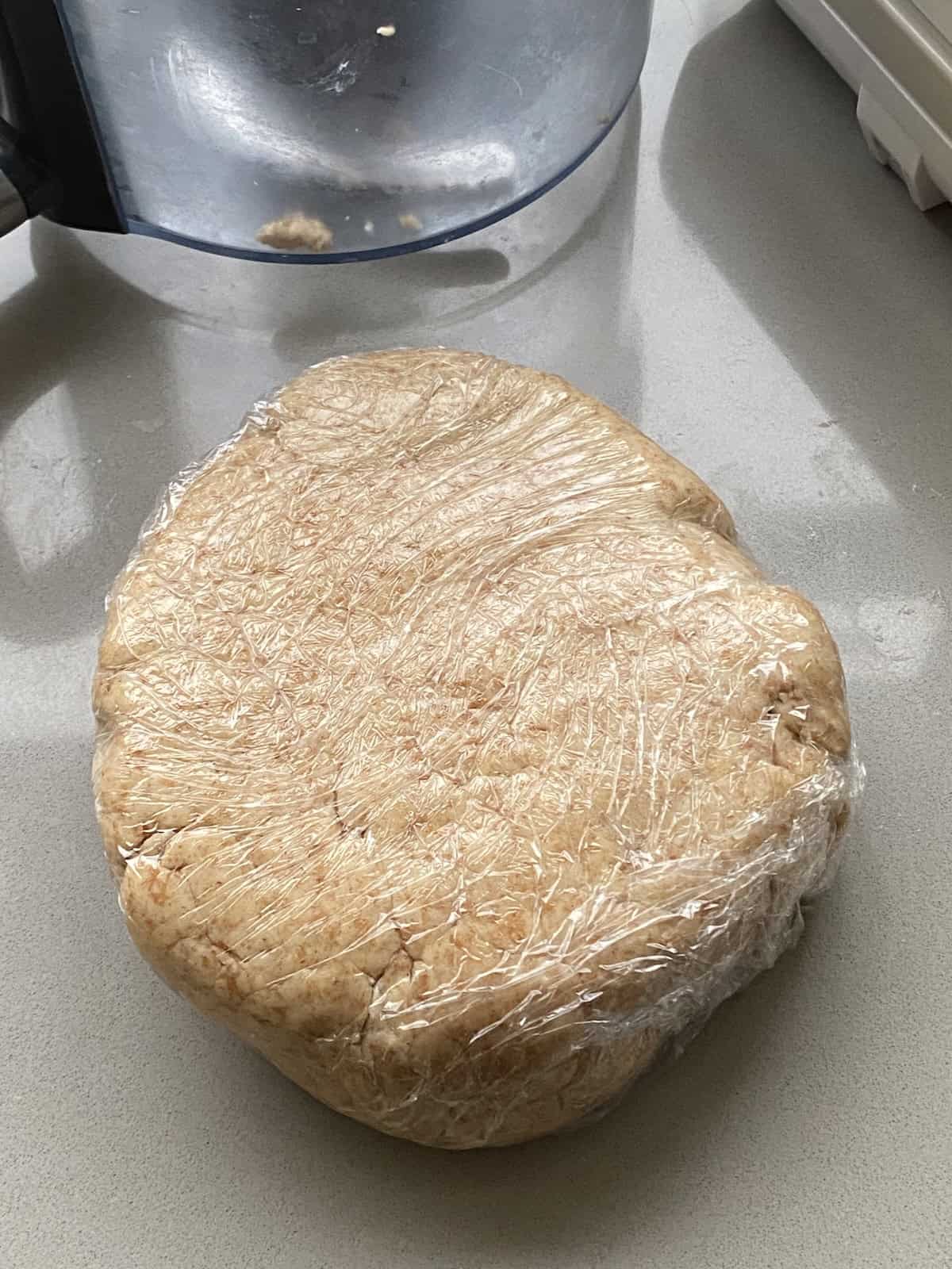 Psastry dough wrapped in clingfilm. Shortcrust pastry wrapped in cling film.