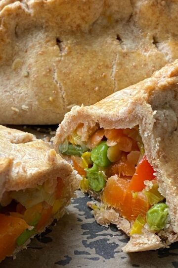 Vegetable and Lentil Pasties sliced in two showing the filling inside.