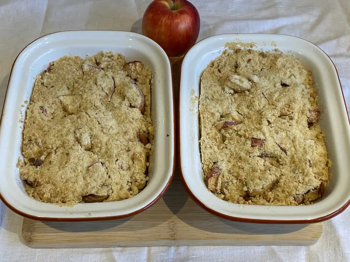 Baked Apple Crumbles in white baking tins.