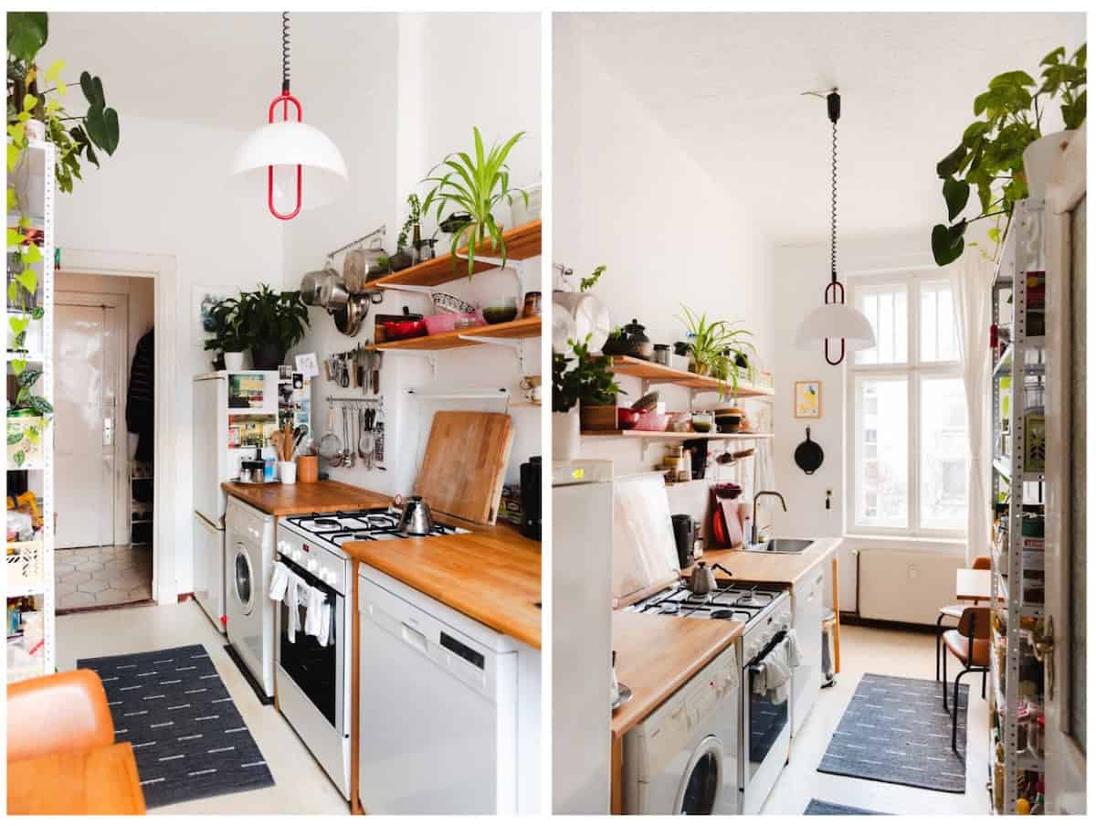 Kitchen with white walls, and open wooden shelves. Devan Grimsrud's light coloured Kitchen.