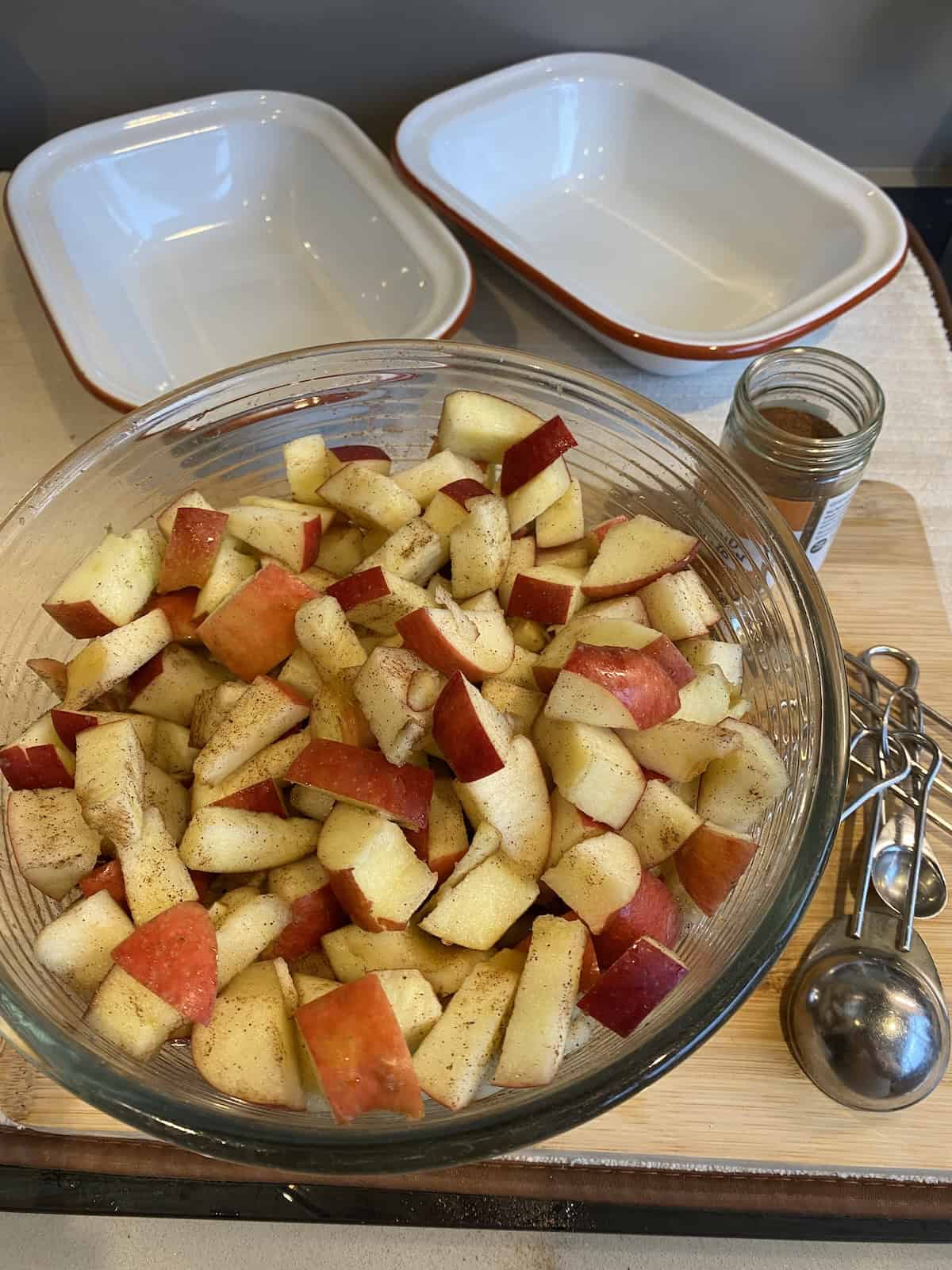 Dish of chopped red apples coated in cinnamon.