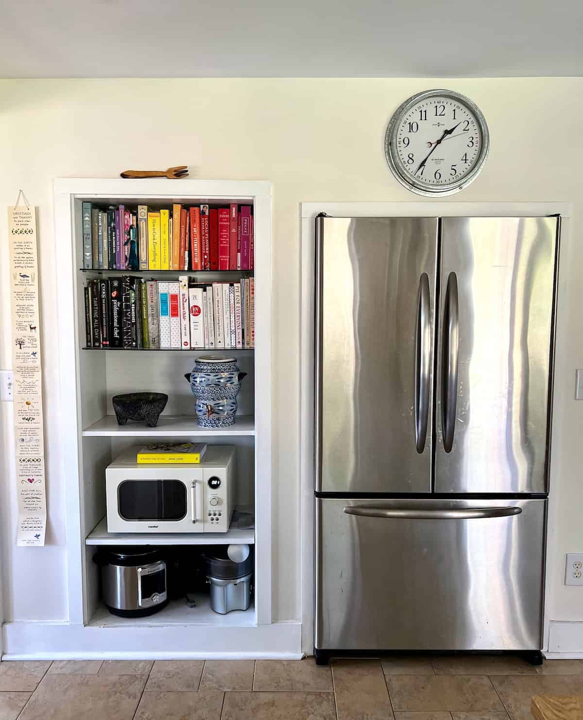 Large fridge with shelves of books on the side. Large Fridge with shelves of books on the sidewall.
