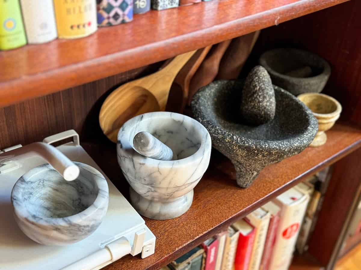 Bookshelf with mortars and pestles.