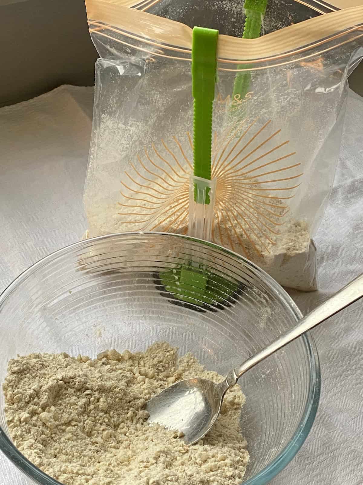 Filling a large freezer bag with crumble mixture.