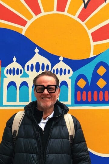 Will Rankin in front of a colourful wall.