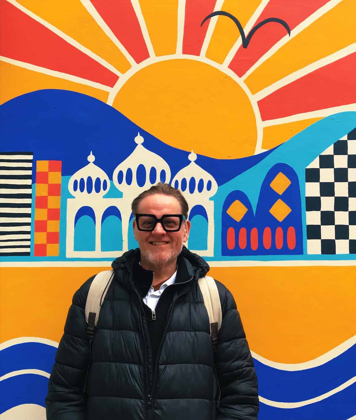 Will Rankin in front of a colourful wall.