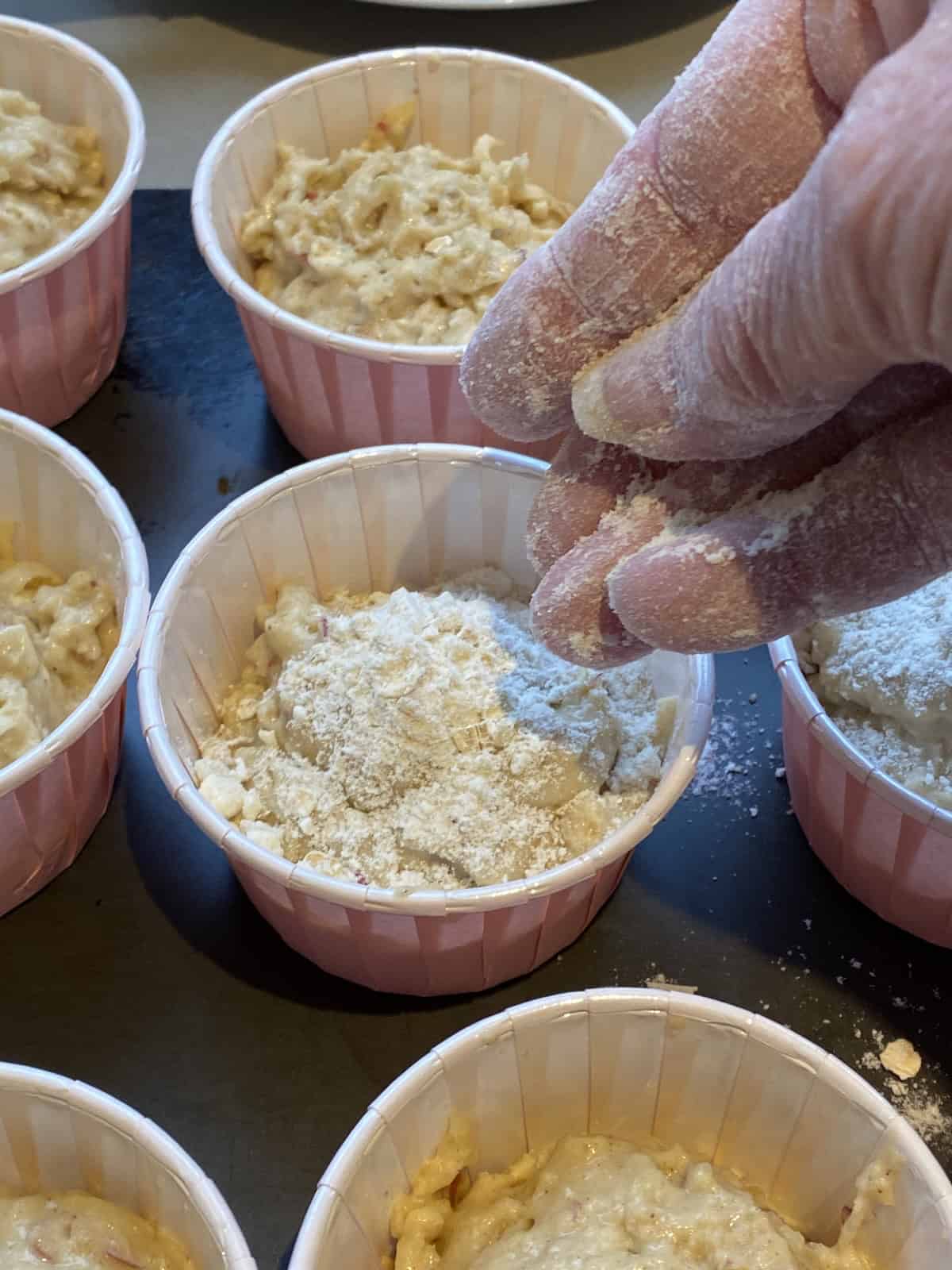 Before baking, sprinkle the top of the muffin batter with streusel topping.