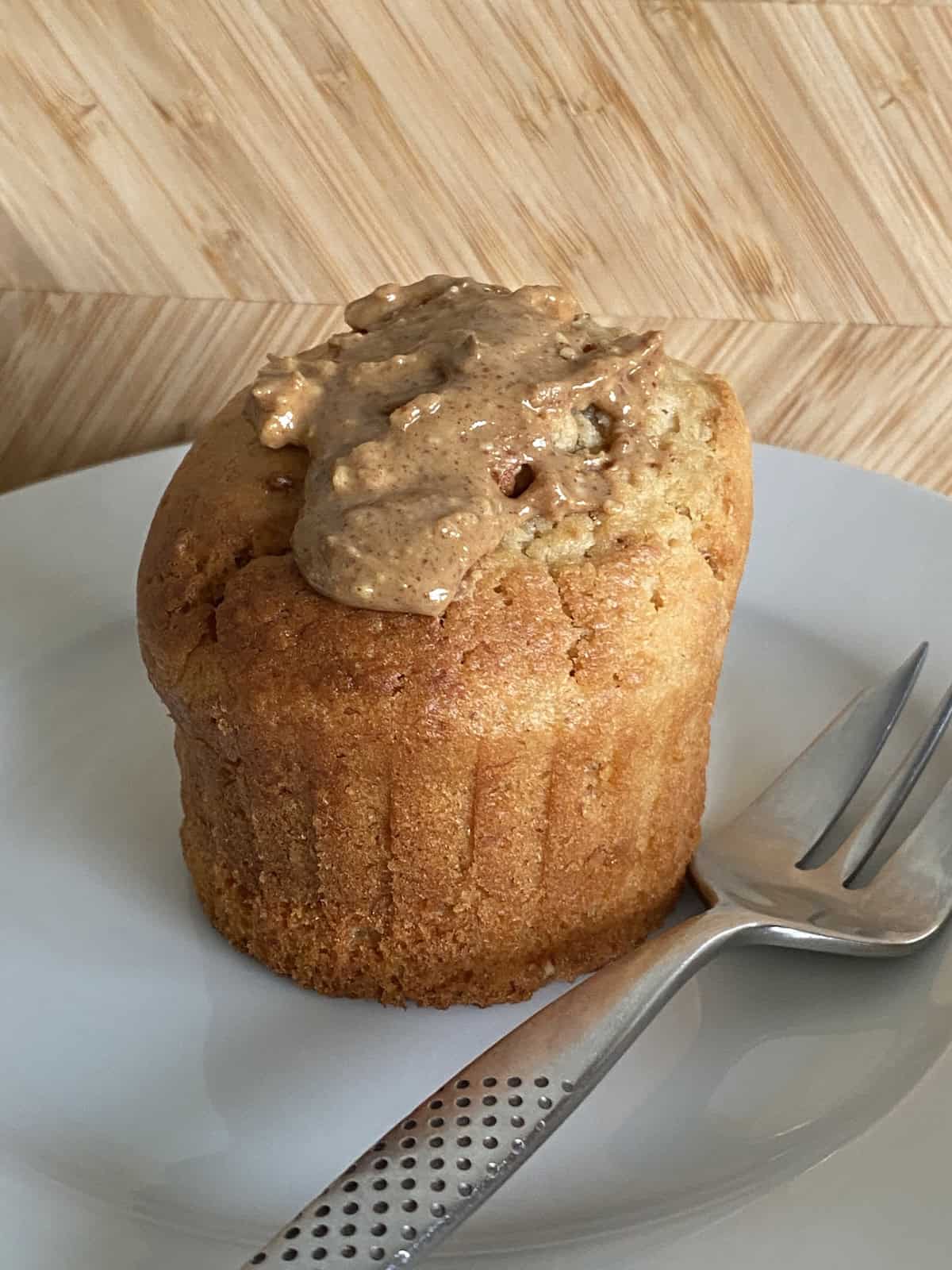 Peanut Butter Muffin on a white plate with a dessert fork on the side.
