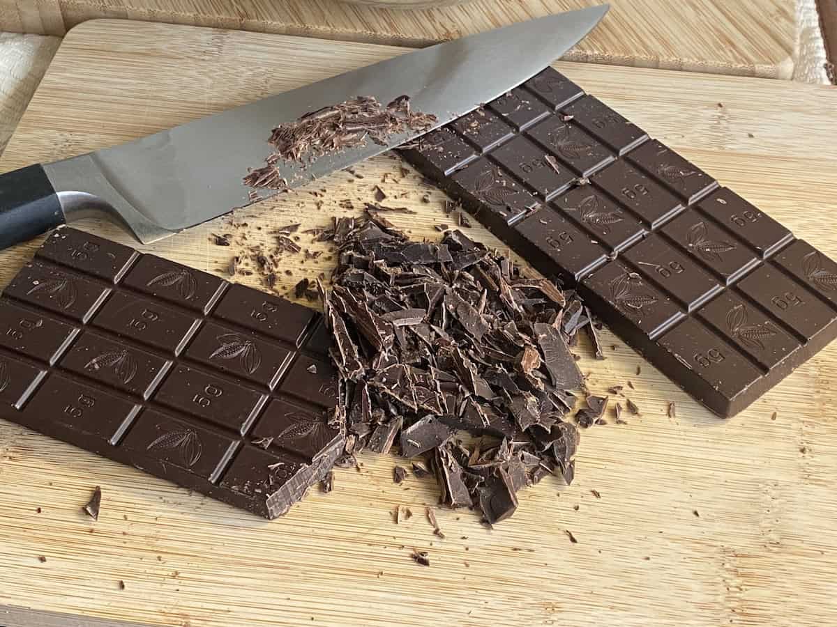 Blocks of chocolate partially chopped into chunks.