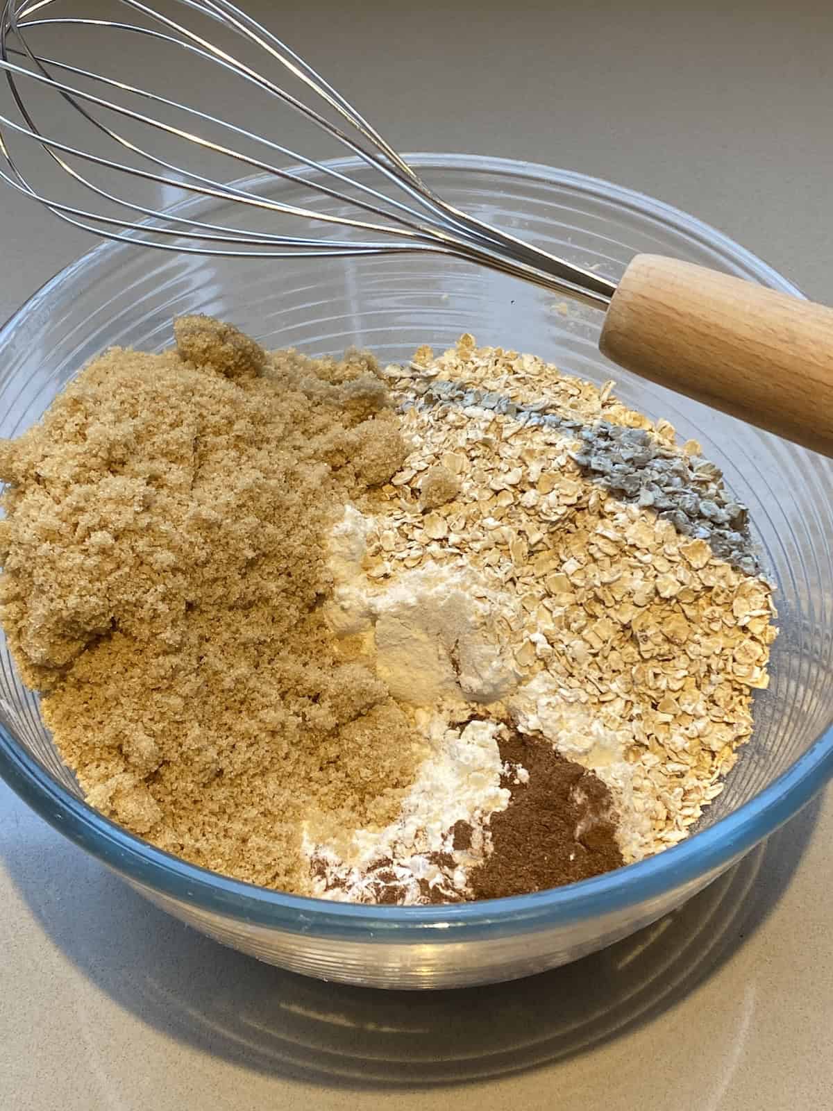 Ingredients for Apple, Oats and Cinnamon Muffins in a large mixing bowl.