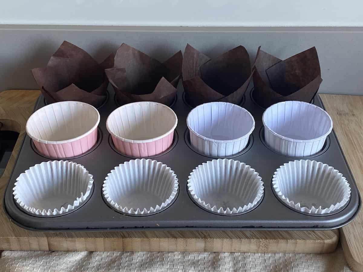 Muffin cases in a muffin tin.
