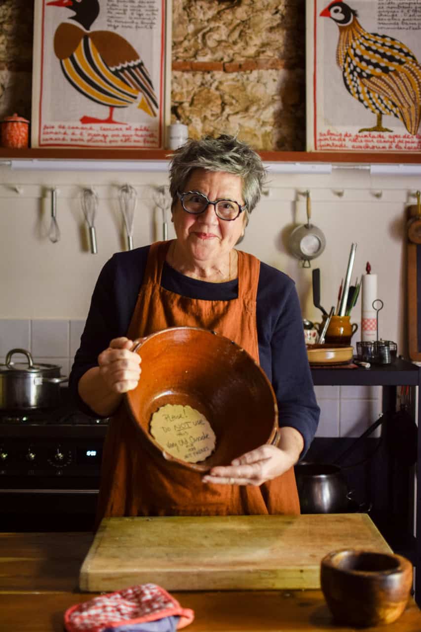 Kate holding a large vintage Cassoulet pot.