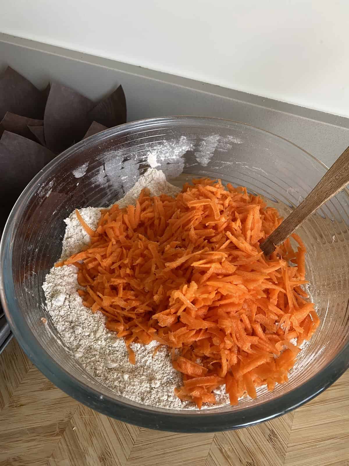 Add grated carrots to the dry ingredients.