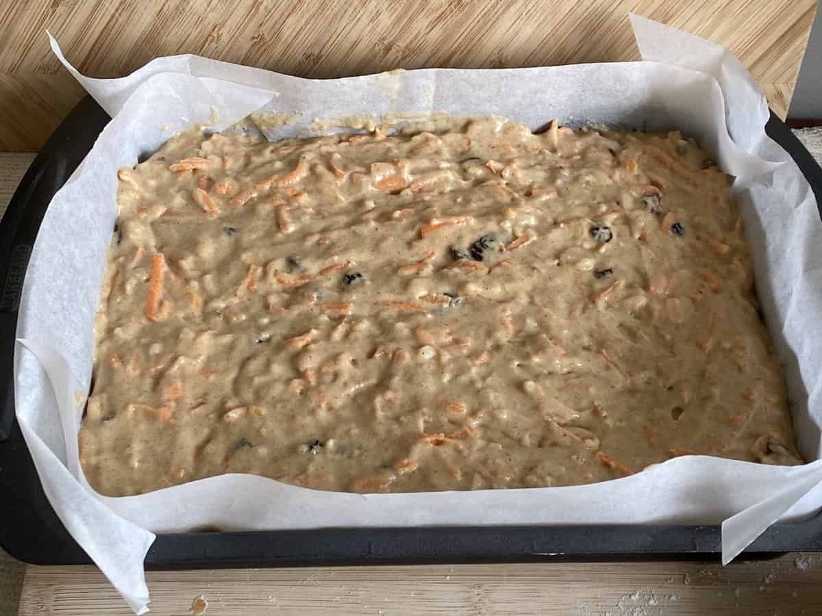 Pour the carrot cake batter into the prepared tin.