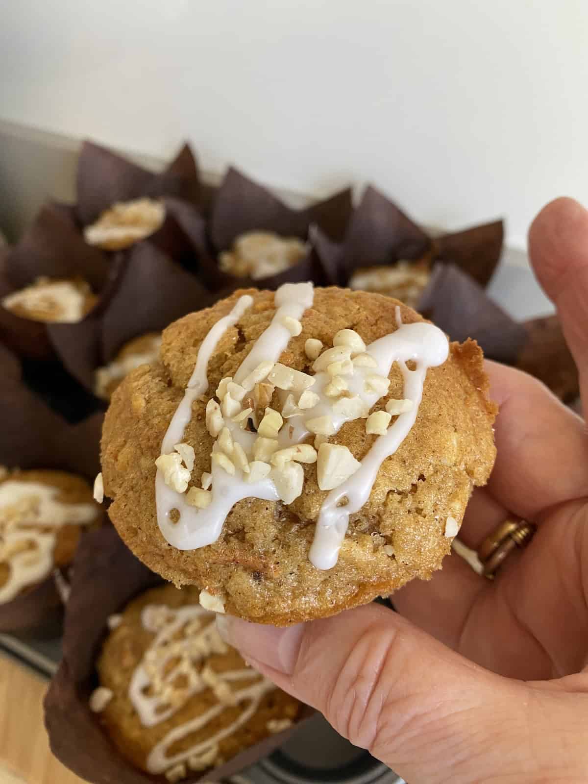 Carrot cake Muffins topped with Icing and nuts.