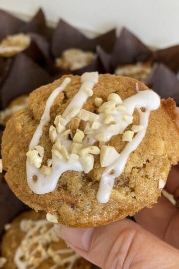 Carrot cake Muffin topped with Icing & nuts.