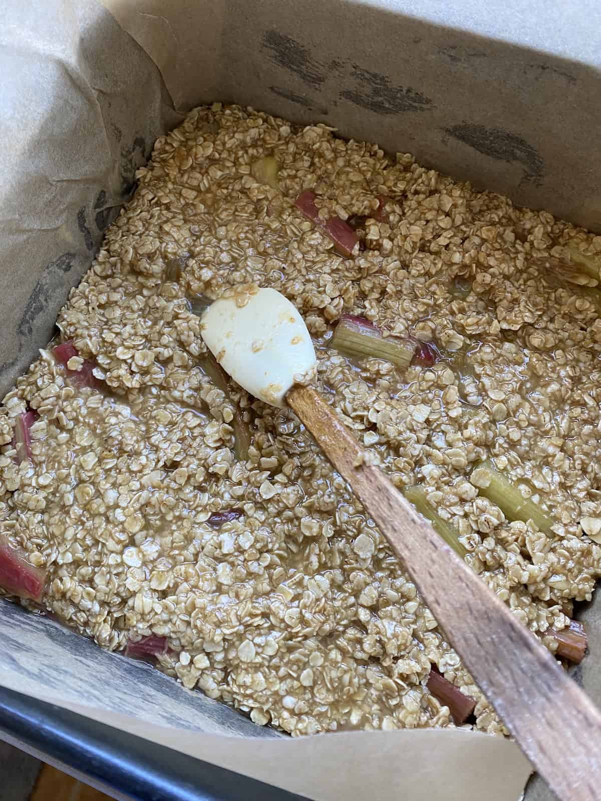 Rhubarb Flapjacks in a square tin ready for baking.